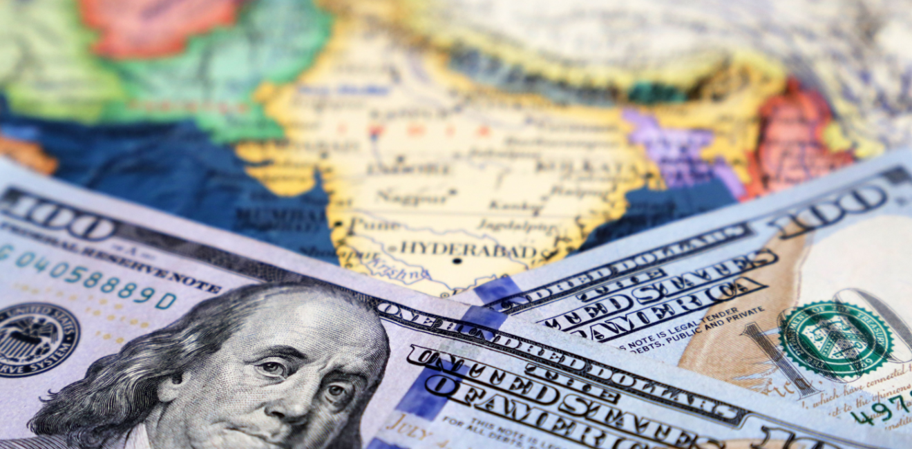 American $100 bills over map of South East asian countries