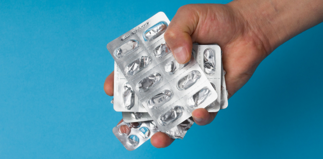 Hand holding empty pill blisters
