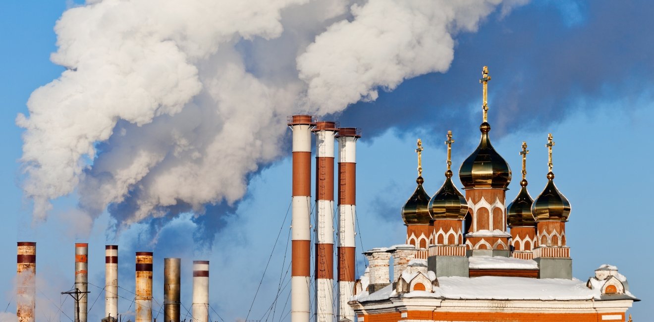 Smoking chimneys over blue sky