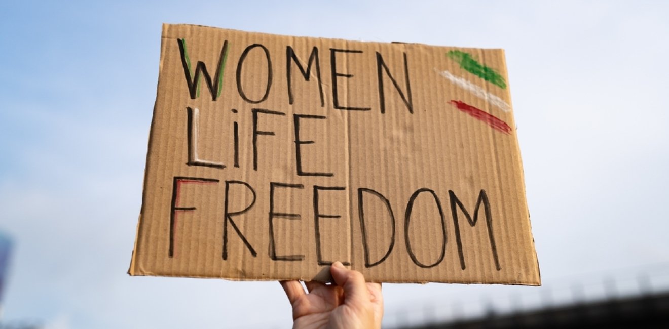 Protest sign reading "Women, Life, Freedom"