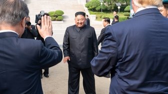 Kim Jong Un waves to President Trump and President Moon at the DMZ.