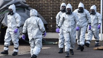 People in hazmat suits clean up the site of the poisoning of Sergei Skripal in Salisbury