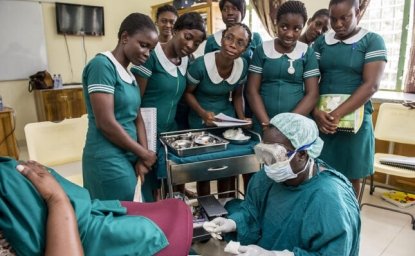Midwife Charity Mote advises students through a simulated birth process in Ghana.