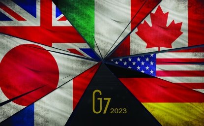 A picture of the seven flags of the G7 countries on fracturing glass shards.