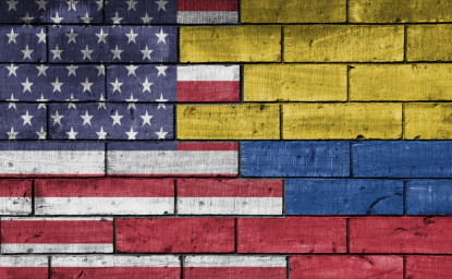 US and Colombian flags painted on a brick wall