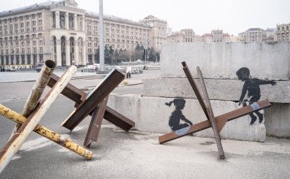 Czech Hedgehogs with street art making it look like children on a seesaw