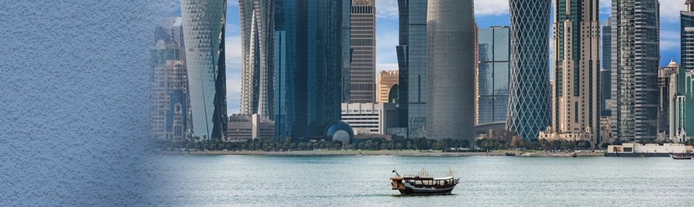 Boat in the water in front of large modern highrises