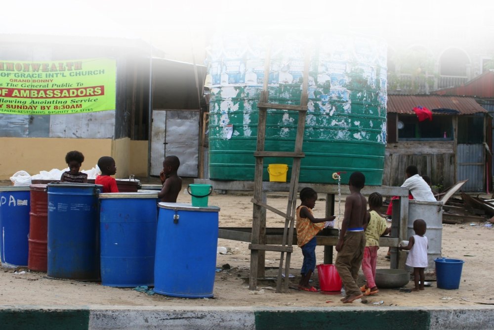 Children filling up buckets with water