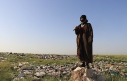 A wastepicker is working amidst dumped solid waste on an informal landfill south of Hasakah, in north east Syria. The defacto authorities in this region are struggling with the public health and environmental impacts due to absence of sound waste management due to conflict. May 10, 2020.