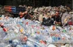Man sifting through plastic waste