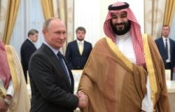 Vladimir Putin shaking hands with Crown Prince of Saudi Arabia Mohammad bin Salman.