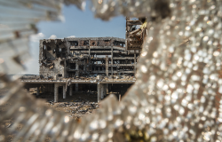 Wide angle view of Donetsk airport ruins through broken glass after massive artillery shelling.