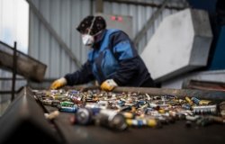  A female worker works on used batteries that are sent to recycling plant.