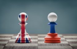 UK and Russia conflict. Country flags on chess pawns on a chess board. 3D illustration.