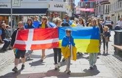 Marchers hold Ukrainian and Danish flags
