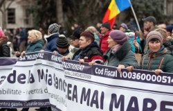 Group of protesters holding long banner
