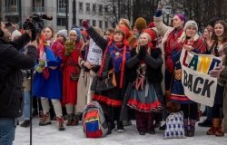 The Sami people, and others, holding a demonstration against the government because of the windmills being built on their land.